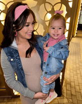 Mom and daughter are wearing matching mommy and me head wraps from By Bella Boutique.